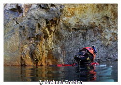Diver at the surface in the cavern section of a flooded m... by Michael Grebler 